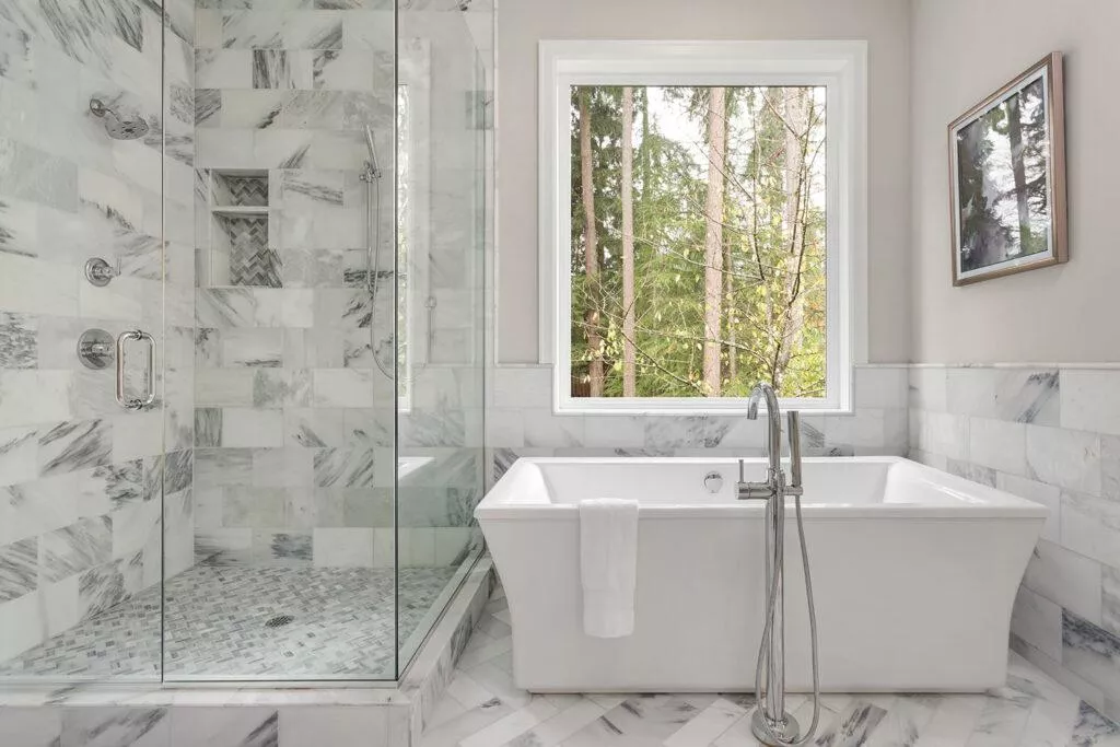 premium bathroom with glass door shower and stunning white marble tiles